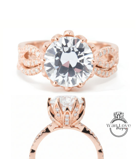 a beautiful rose gold ring with a large, clear gemstone set in the center. The ring has a delicate, intricate design with a floral motif and a prominent, sparkling gemstone.