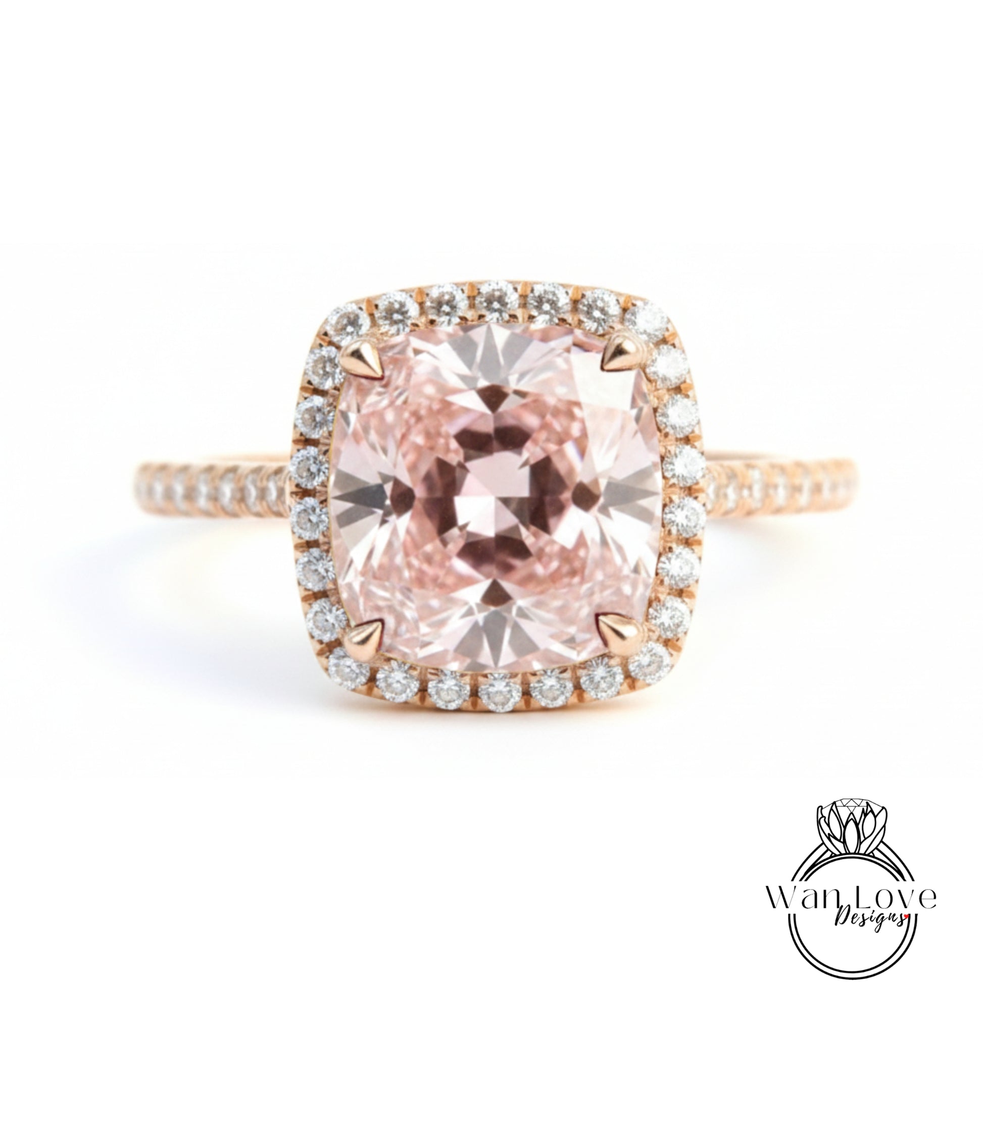 A stunning engagement ring with a large, pink gemstone set in a halo of smaller diamonds, surrounded by a delicate gold band.