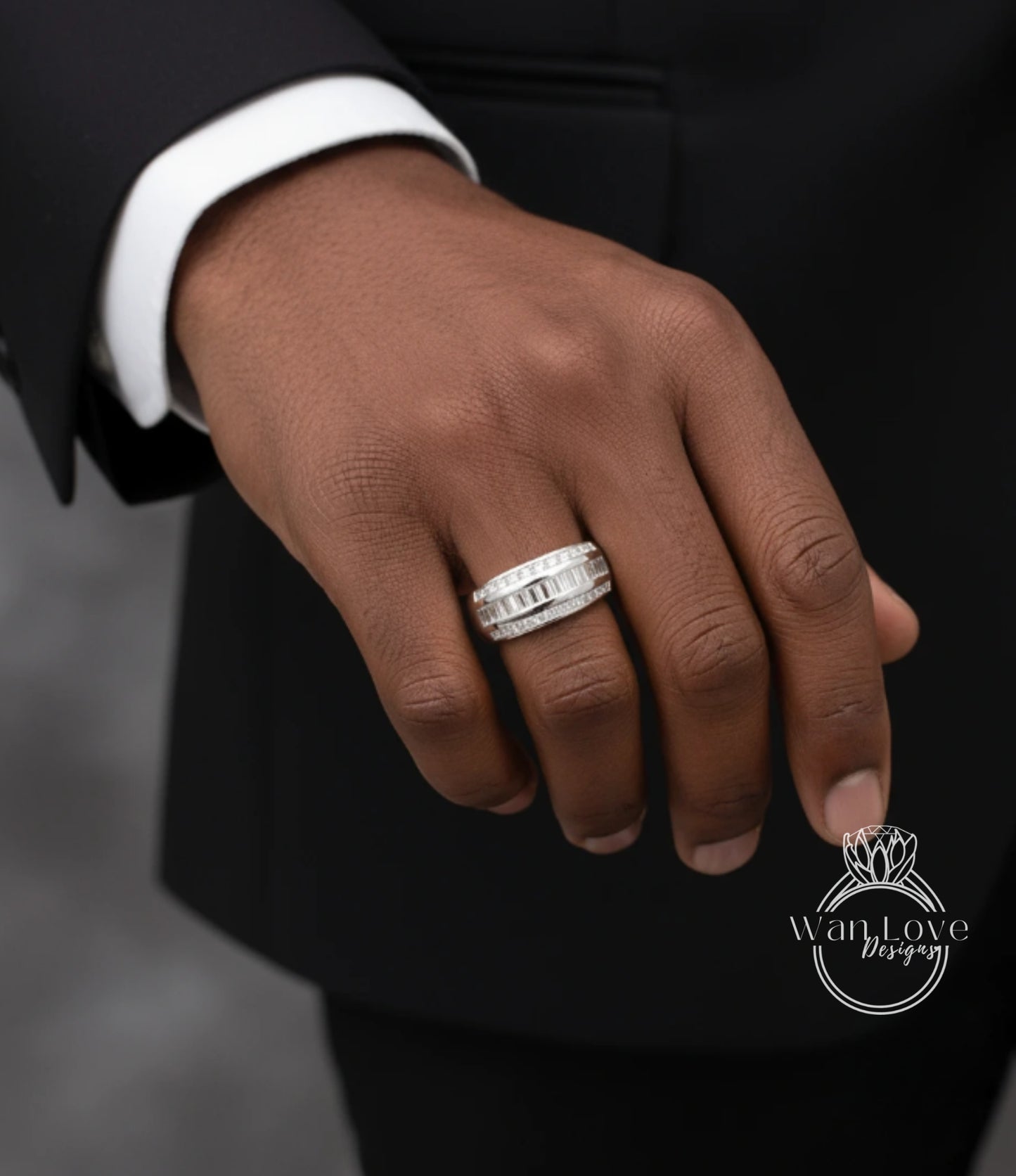 A close-up of a person's hand wearing a diamond ring on the ring finger.