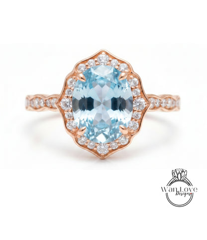 A beautiful ring featuring a large oval-shaped blue gemstone surrounded by a halo of smaller diamonds set in a rose gold band.