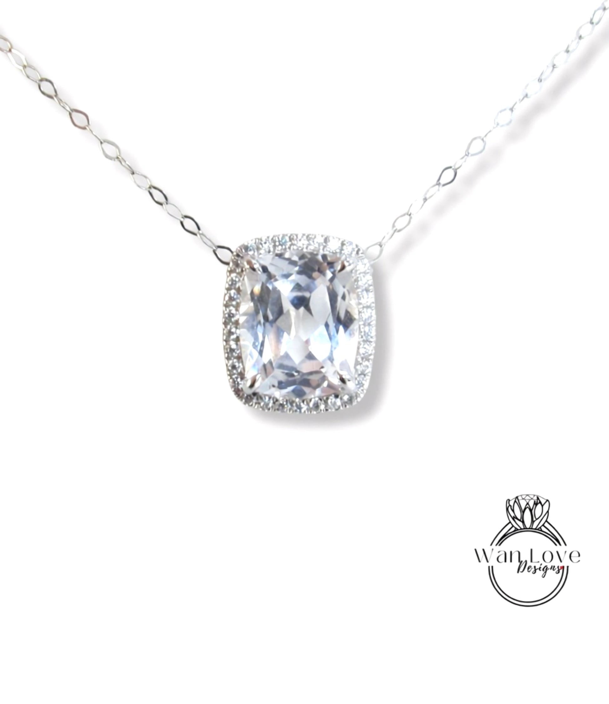 A necklace with a large, clear gemstone pendant, possibly a diamond, surrounded by smaller diamonds.