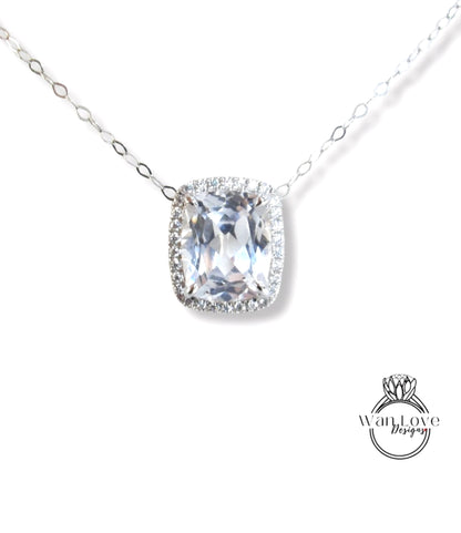 A necklace with a large, clear gemstone pendant, possibly a diamond, surrounded by smaller diamonds.