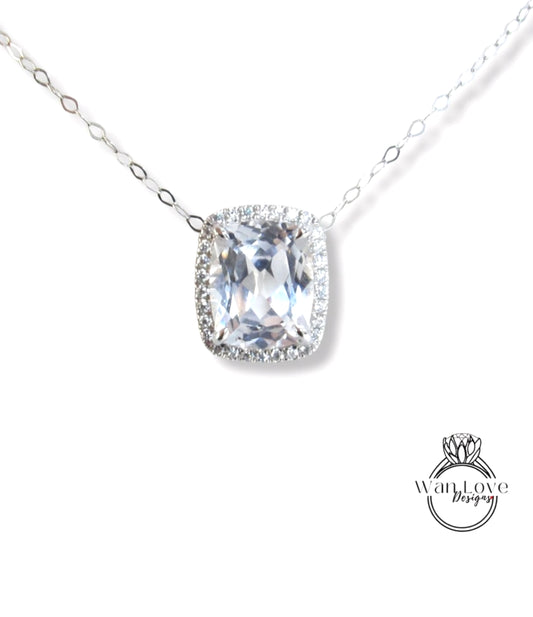 A necklace with a large, clear gemstone pendant, possibly a diamond, surrounded by smaller diamonds.