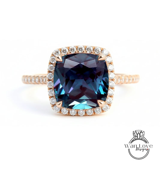 A large, blue gemstone ring with a halo of smaller diamonds around the center stone.