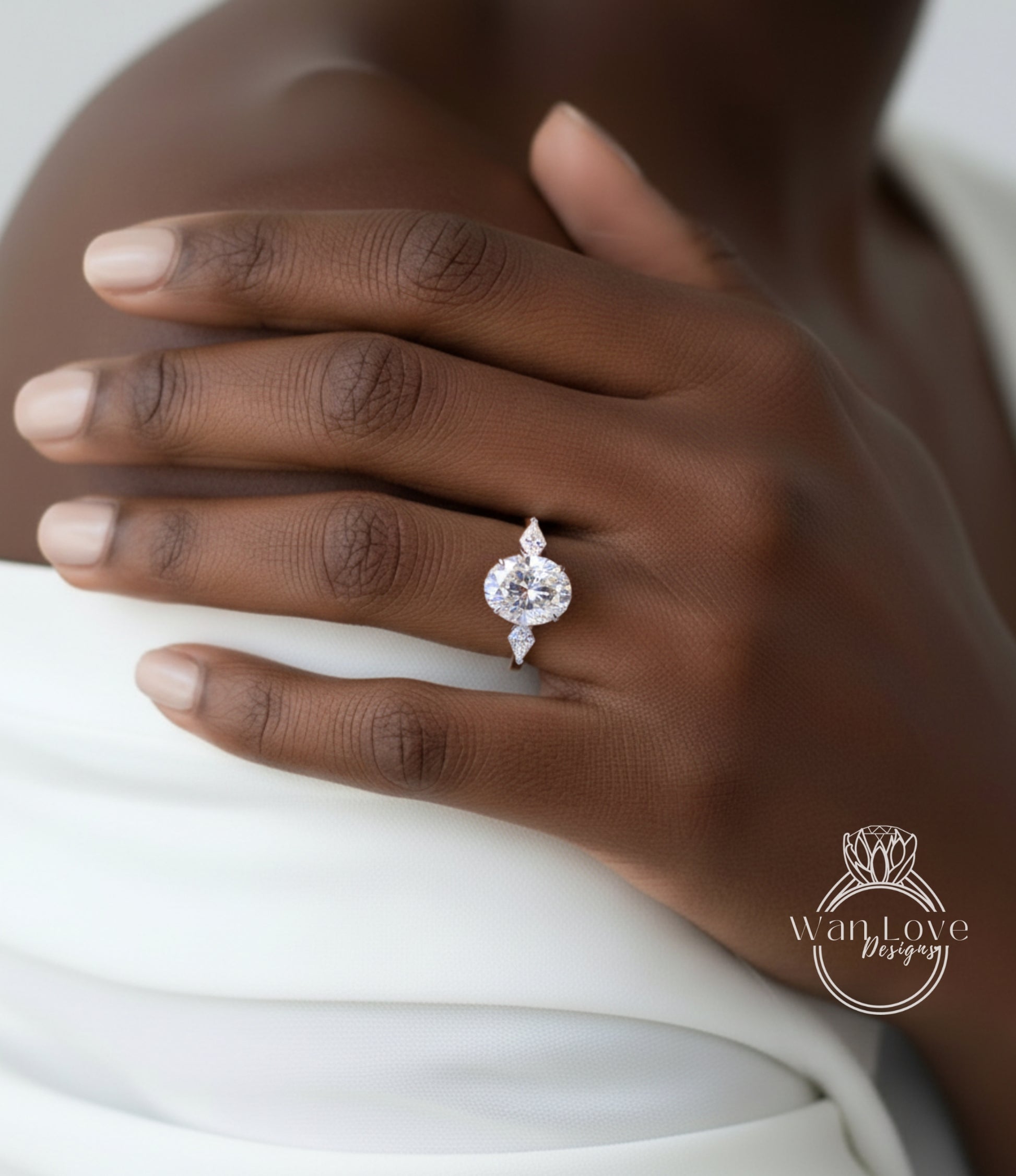 A close-up of a person's hand wearing a diamond engagement ring.