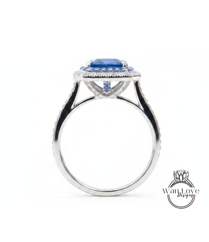 A silver ring with a large blue gemstone at the center, surrounded by smaller diamonds.