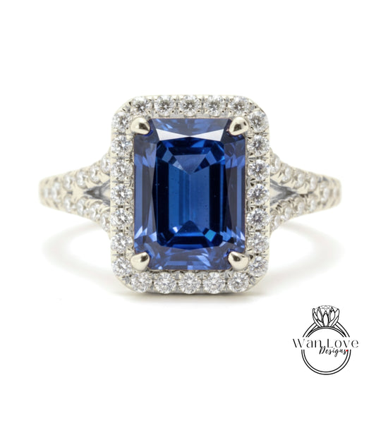 A stunning blue sapphire engagement ring with a halo of diamonds set in a silver band.