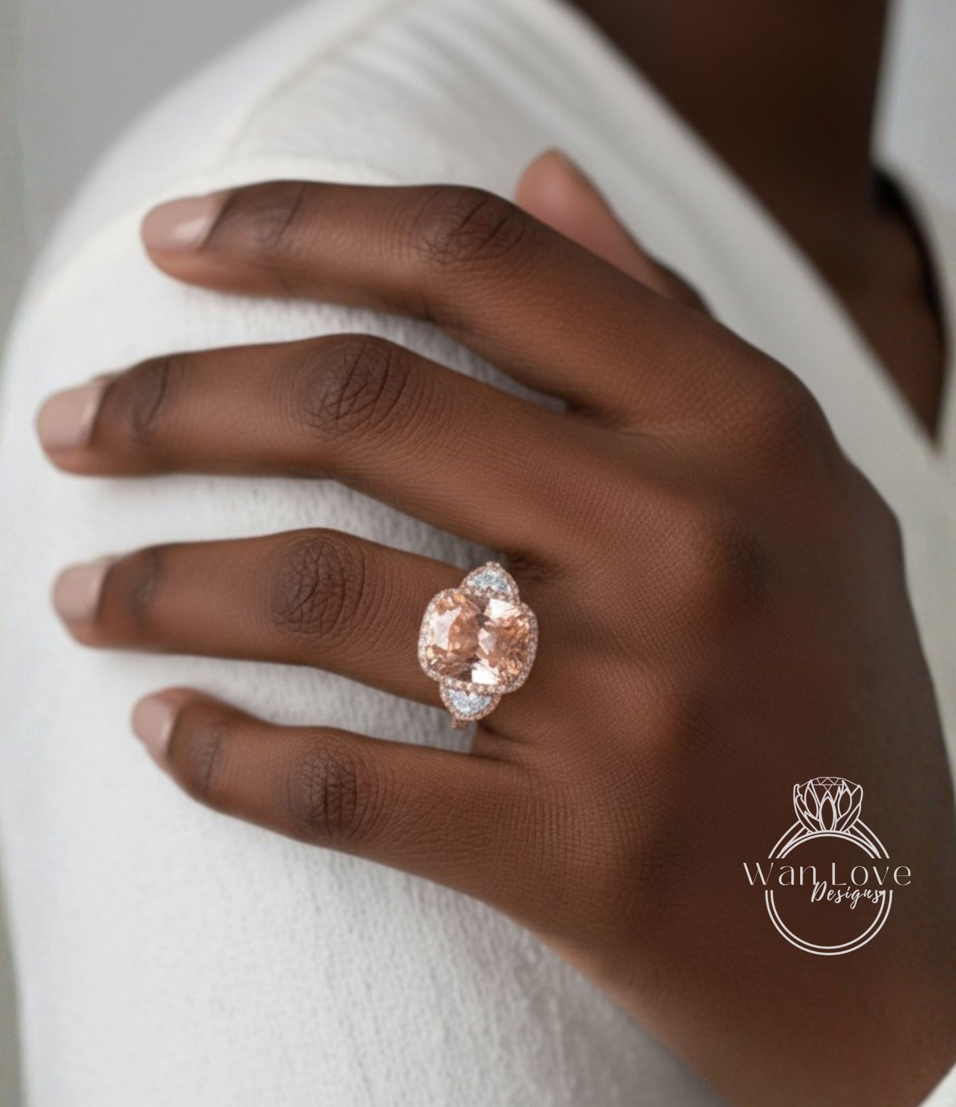 A close-up of a person's hand wearing a large, ornate ring with a large, round gemstone.
