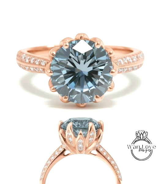 a beautiful blue diamond ring with a large central stone surrounded by smaller stones. The ring is set in a rose gold band with a scalloped edge, and the overall design is elegant and eye-catching.