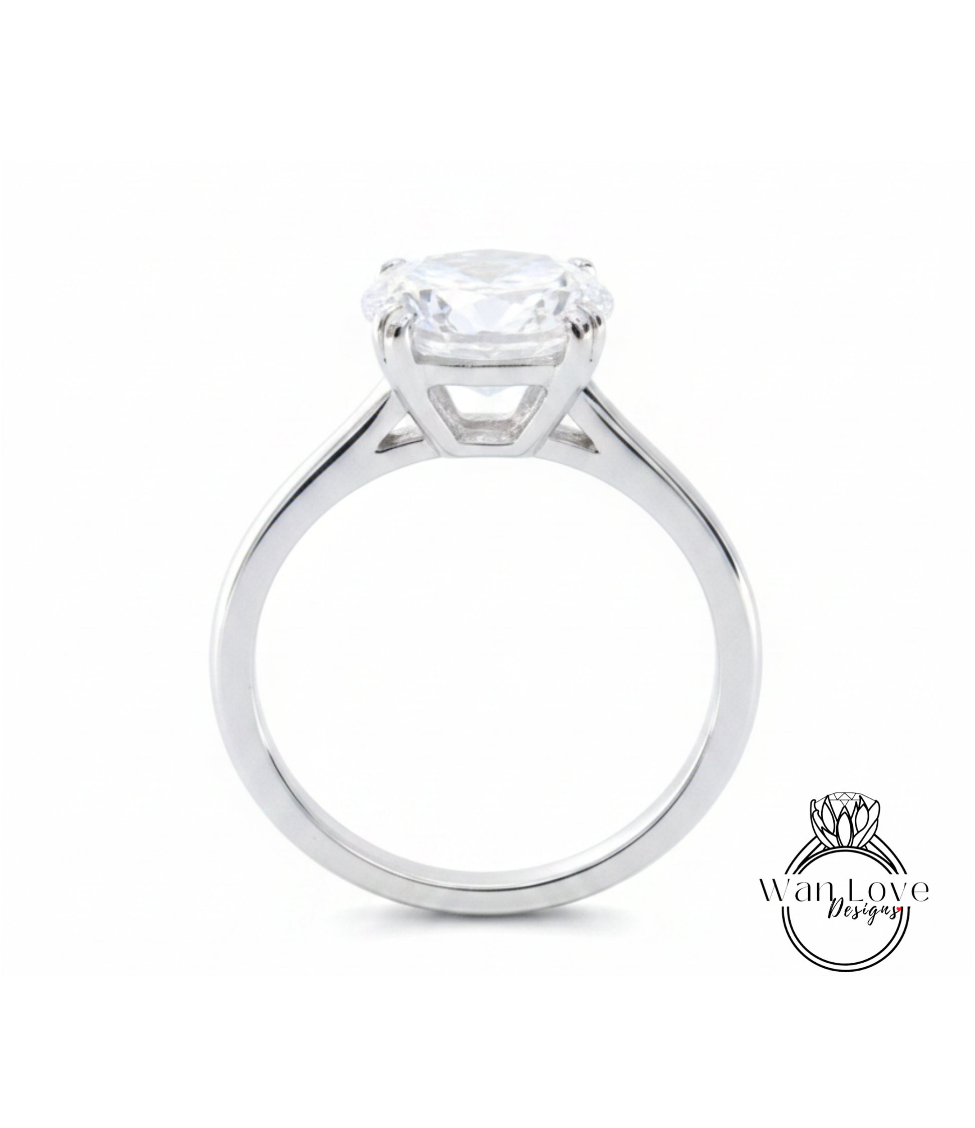 A silver engagement ring with a large, clear gemstone set in the center of the band.