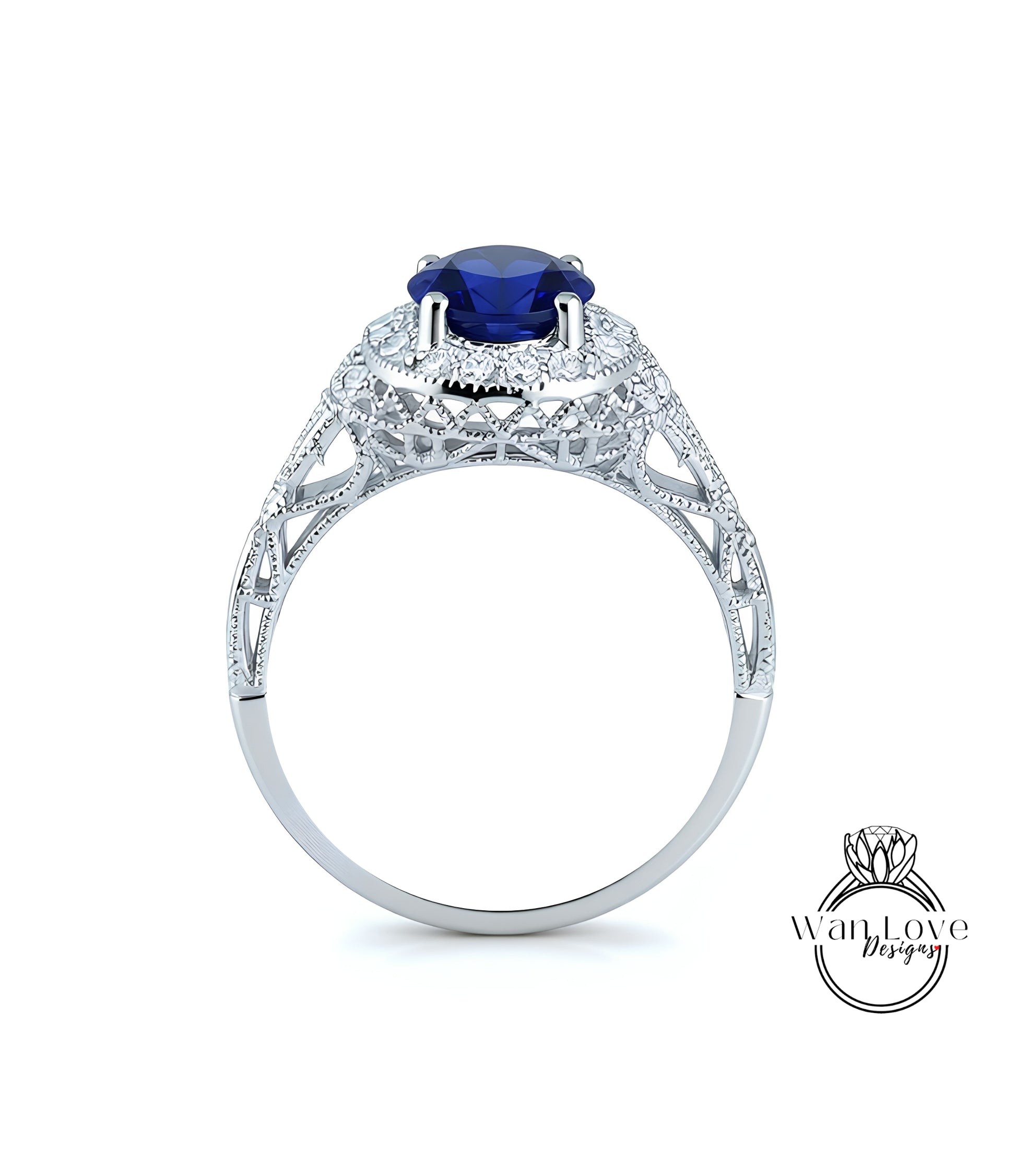A silver ring with a large blue gemstone, possibly a sapphire, set in an intricate, ornate design.