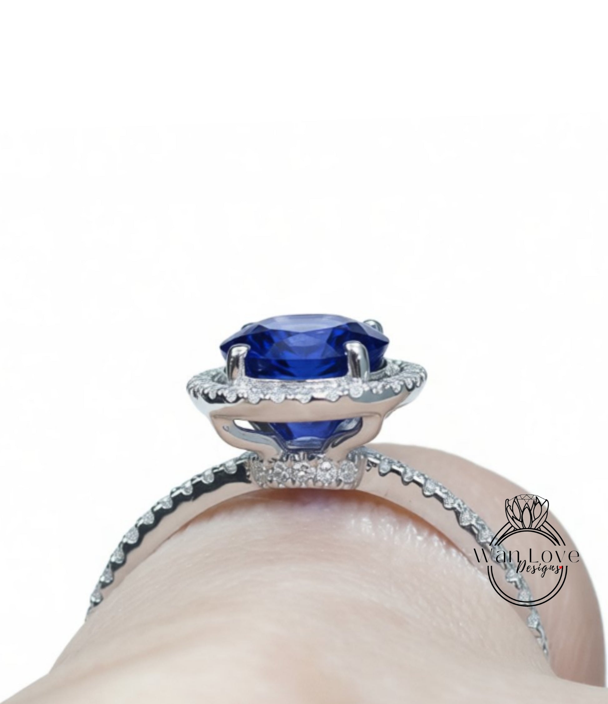 A close-up view of a diamond engagement ring with a large blue gemstone set in a halo of smaller diamonds.