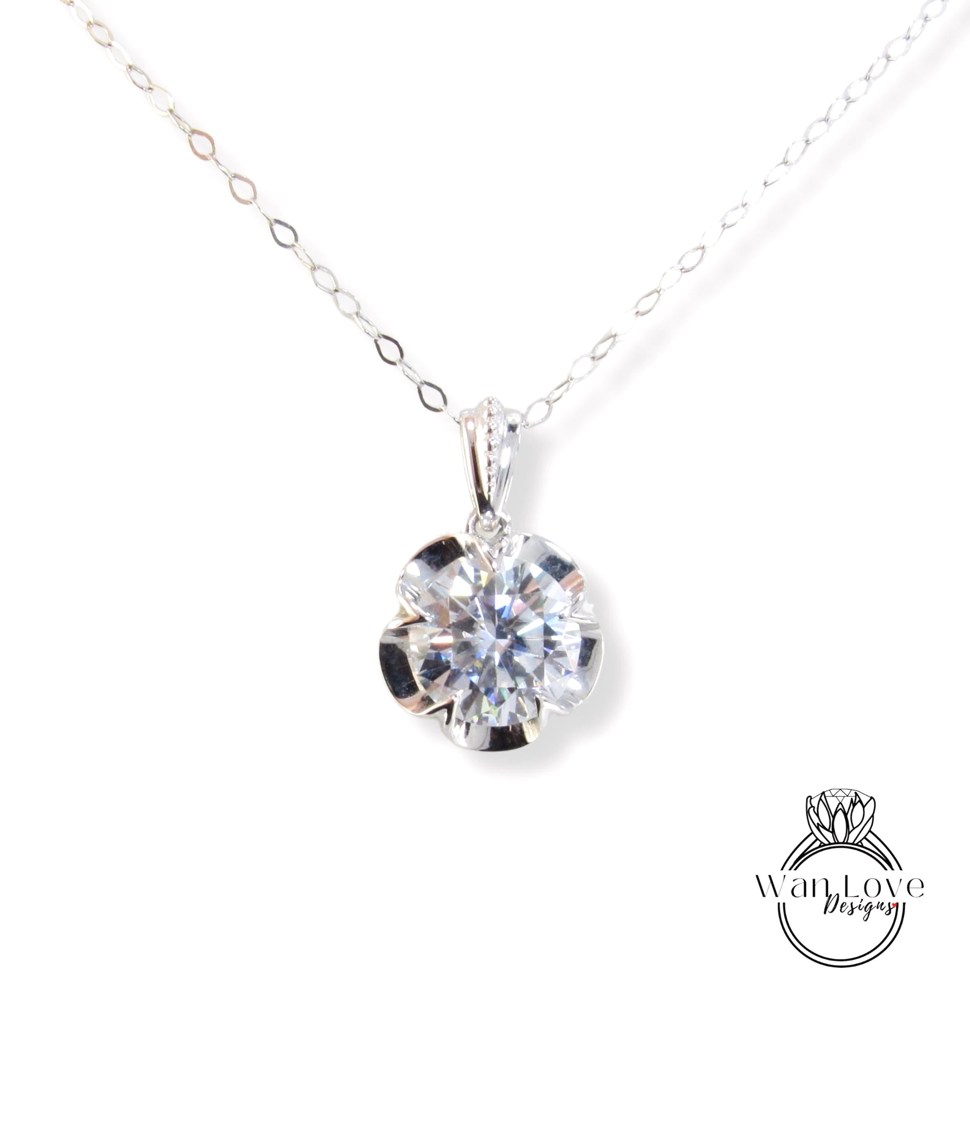 A close-up view of a delicate necklace with a large, brilliant-cut diamond pendant hanging from a chain.