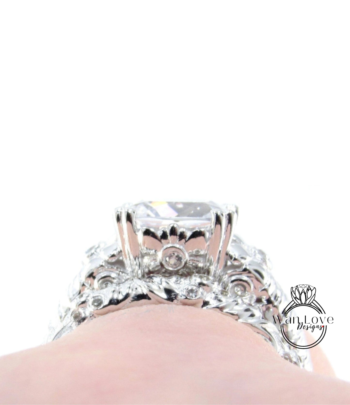 A close-up view of a diamond engagement ring on someone's hand, showcasing the intricate design and sparkling gemstone.