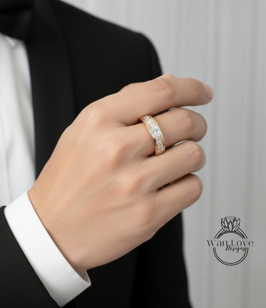 A close-up of a person's hand wearing a gold ring with a diamond.
