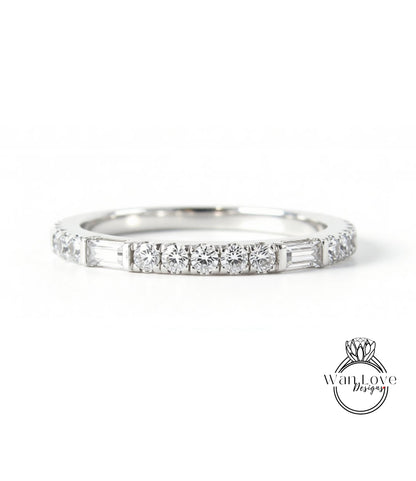 A silver band ring with a row of diamonds set in it.