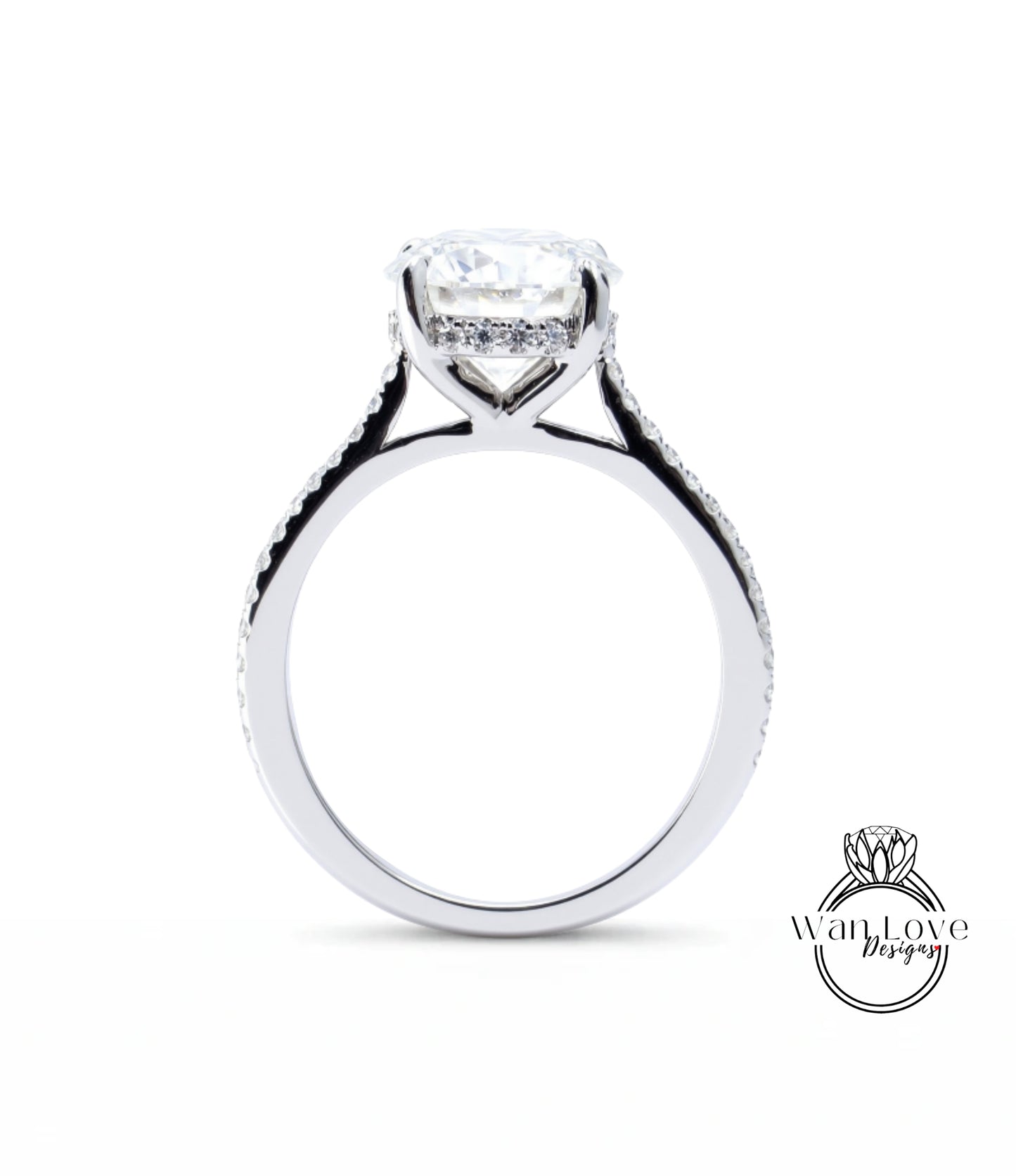 A close-up view of a silver engagement ring with a large central diamond and a halo of smaller diamonds around the center stone.