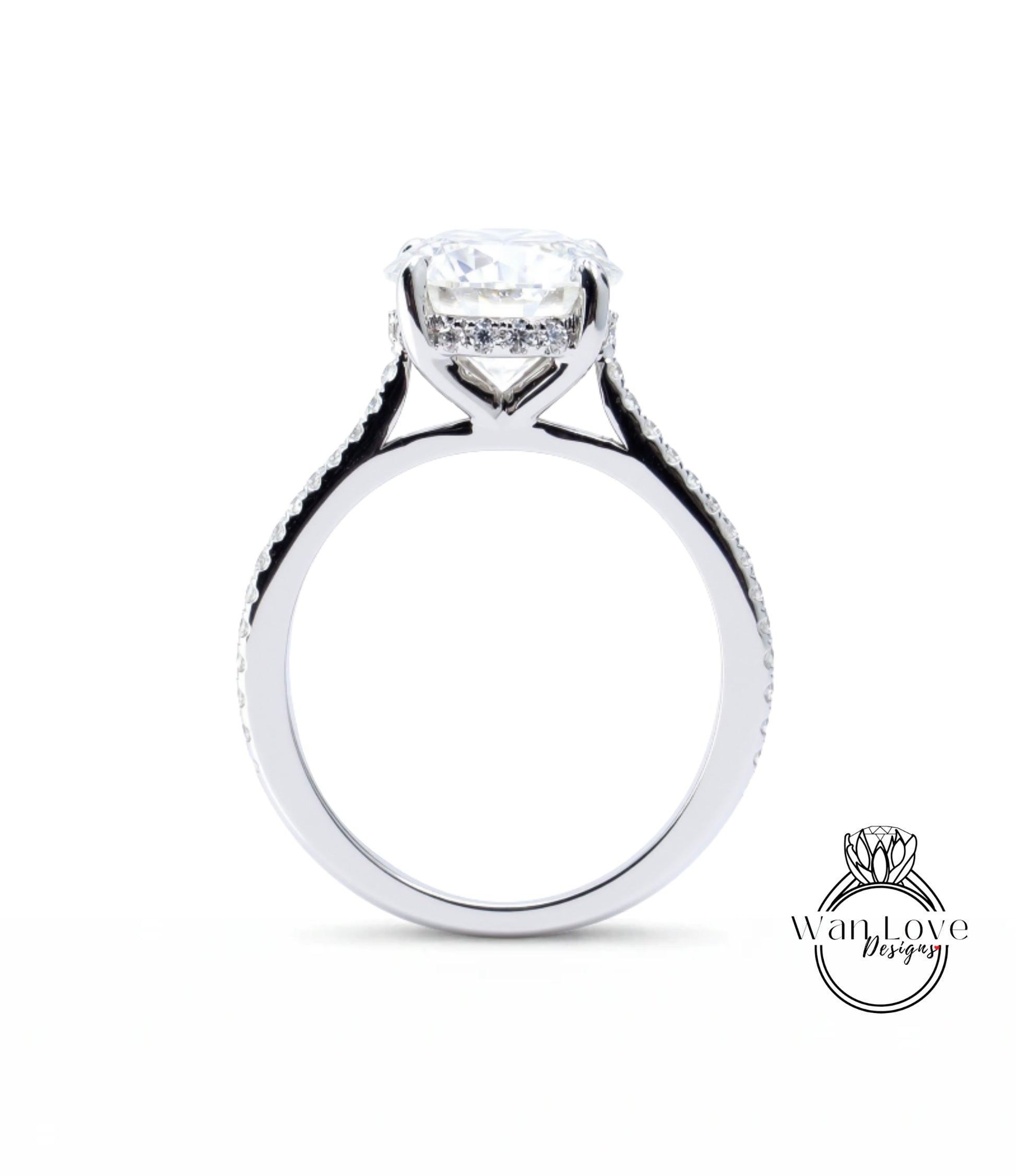 A close-up view of a silver engagement ring with a large central diamond and a halo of smaller diamonds around the center stone.
