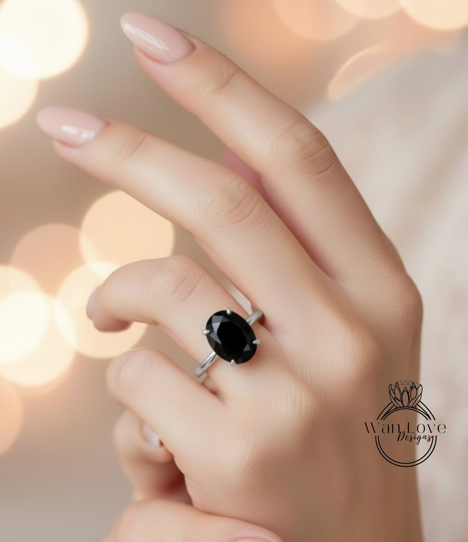 A close-up of a hand wearing a ring with a large black gemstone, against a blurred background with bokeh lighting.