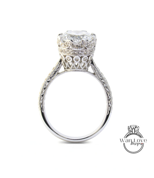 A silver engagement ring with a large central diamond and intricate metalwork detailing around the band.