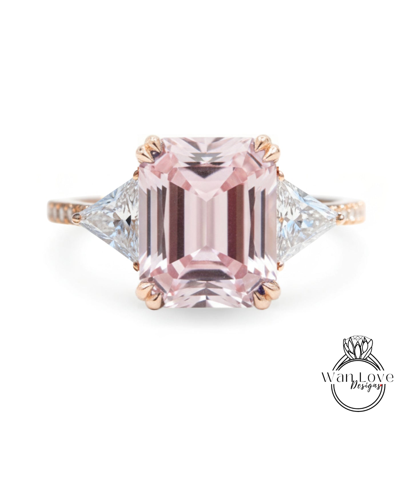 A pink gemstone engagement ring with a large central pink gemstone surrounded by smaller diamonds on either side.