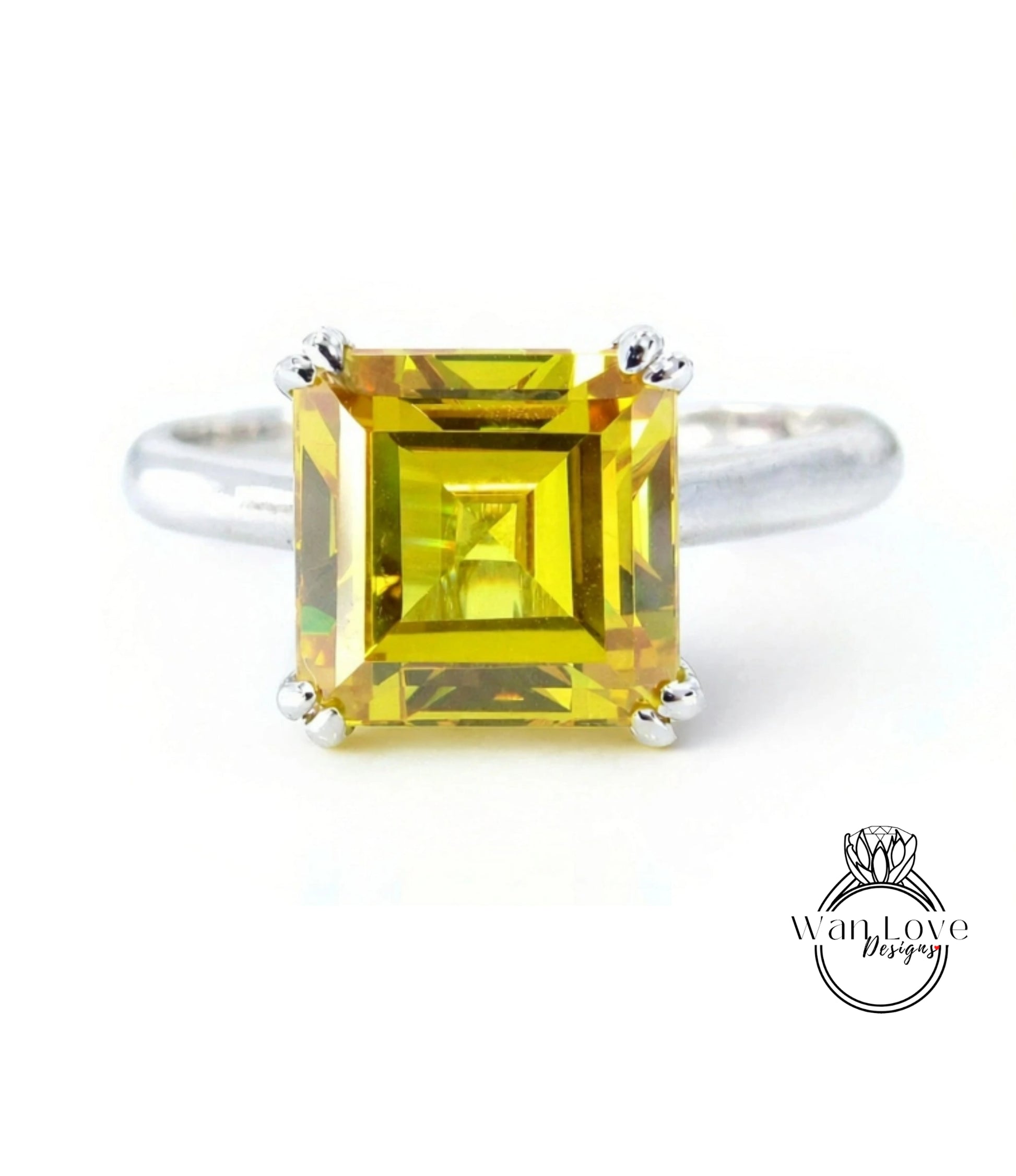 A ring with a large, square yellow gemstone set in a silver band.