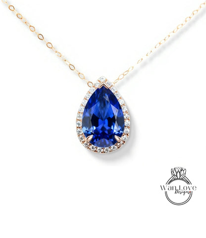 A close-up of a beautiful blue gemstone pendant with a halo of smaller diamonds around it, set in a gold chain.