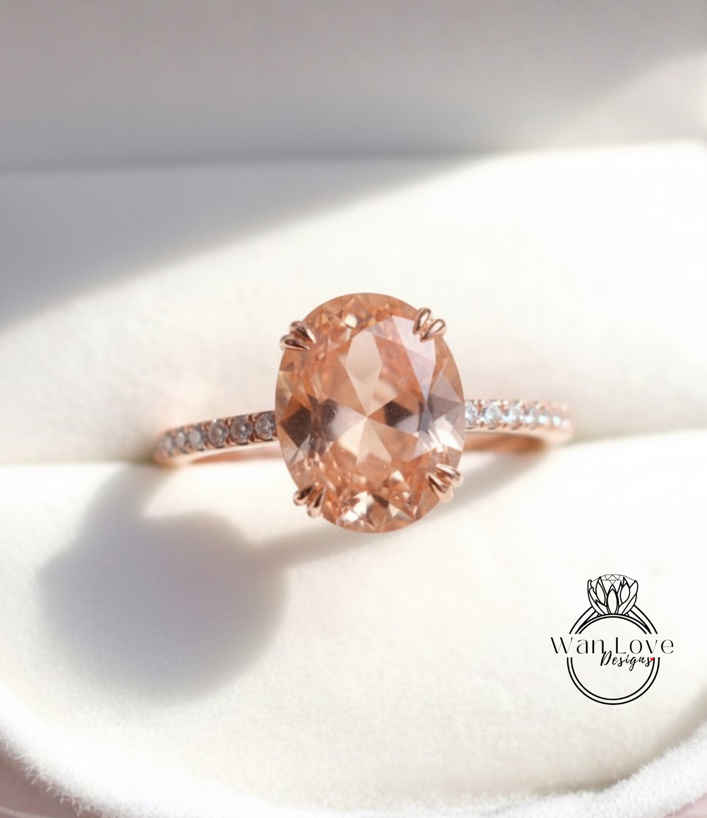 A close-up image of a rose gold engagement ring with a large oval-shaped gemstone set in the center, surrounded by smaller diamonds.