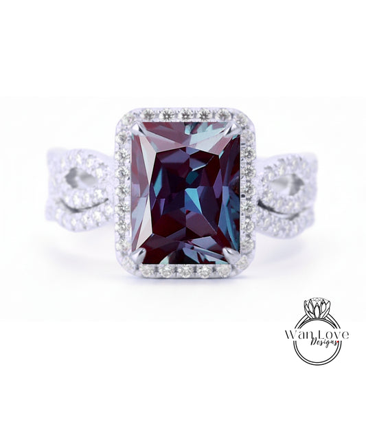 A large, rectangular purple gemstone set in a silver ring with a halo of smaller diamonds around the edges.