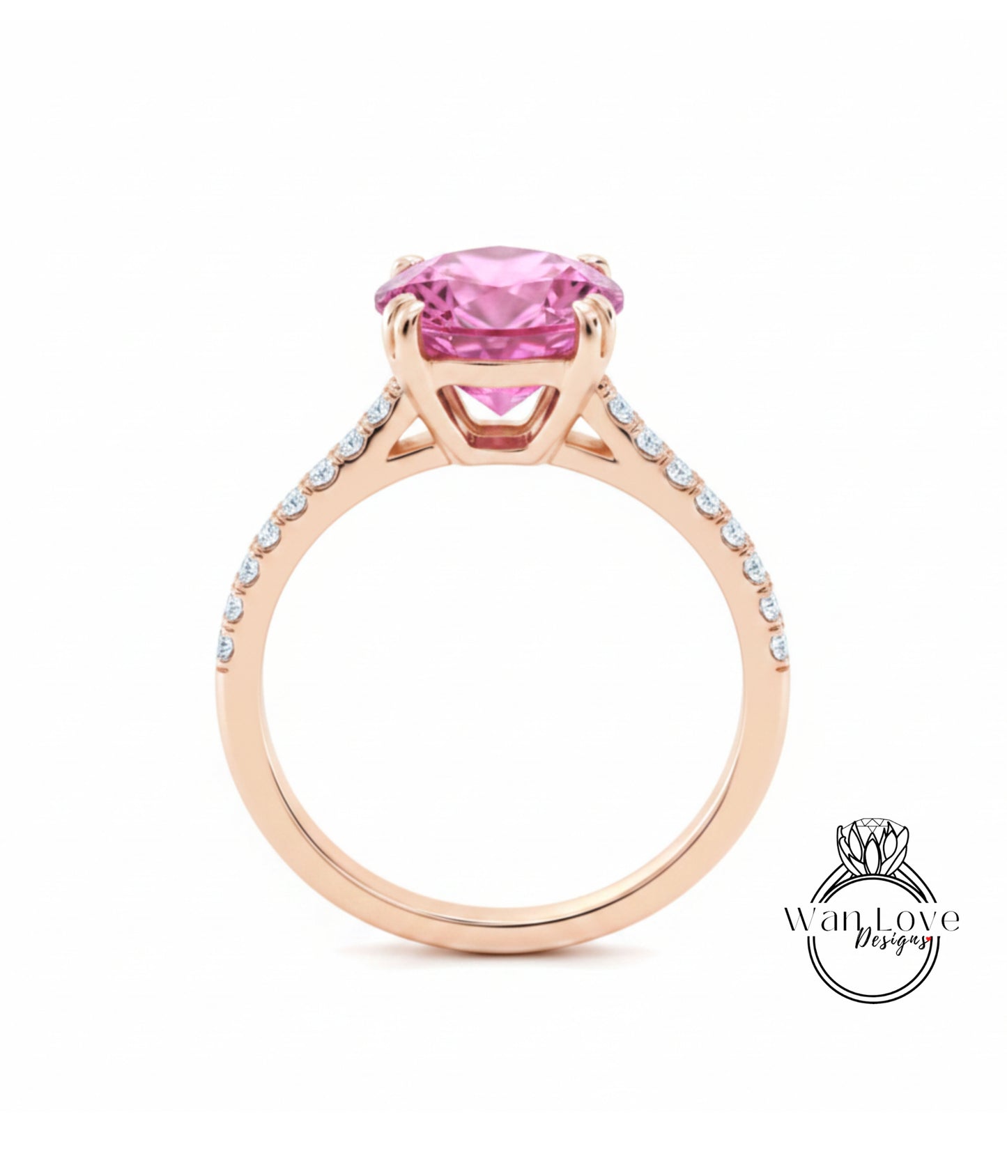 A gold ring with a large pink gemstone, likely a pink diamond, set in the center.