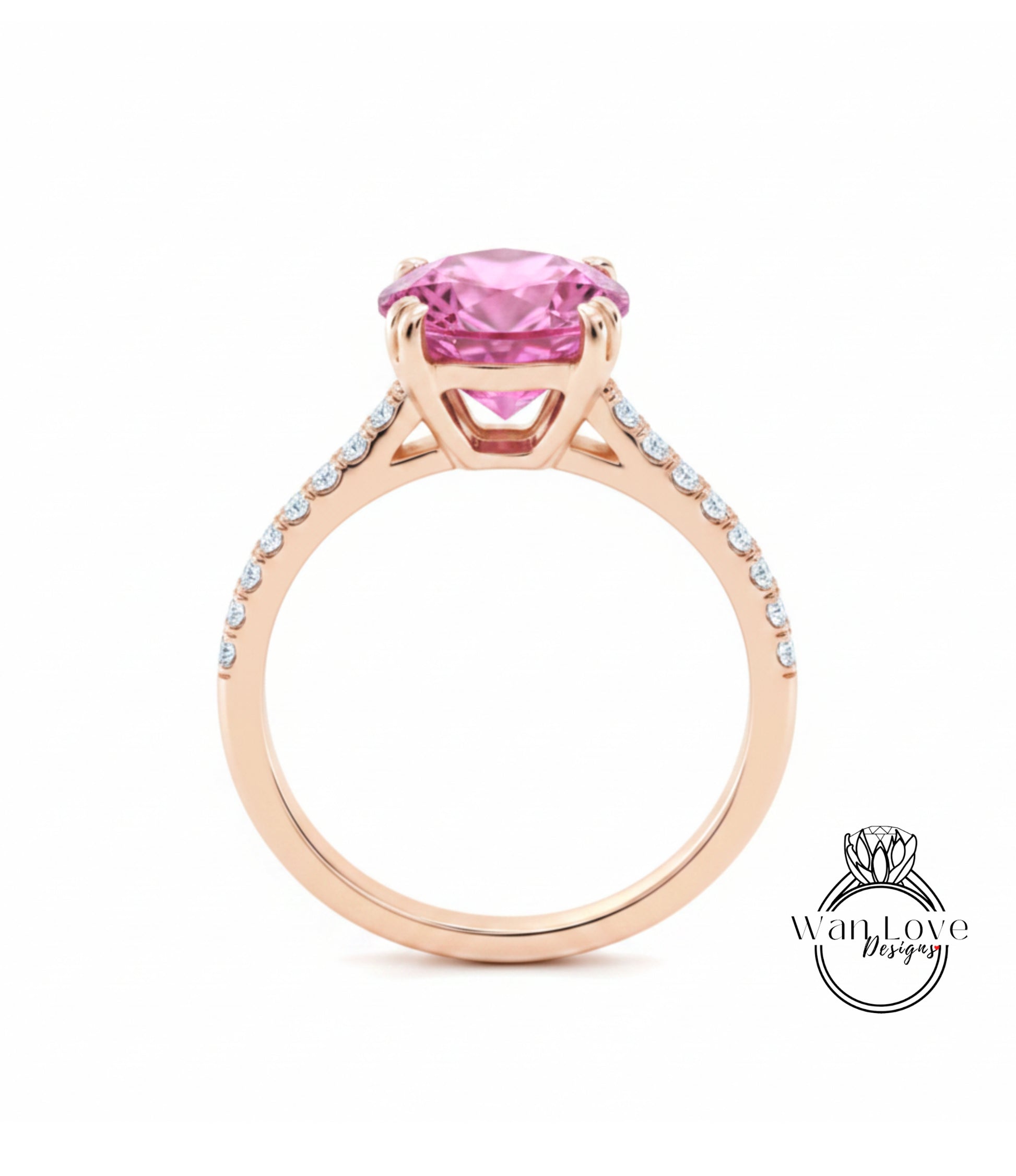 A gold ring with a large pink gemstone, likely a pink diamond, set in the center.