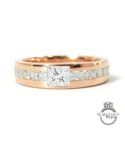 A rose gold ring with a large central diamond and smaller diamonds along the band.