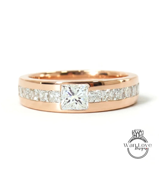 A rose gold ring with a large central diamond and smaller diamonds along the band.