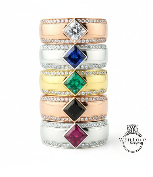 A stack of rings with various gemstones and designs, including a ring with a large diamond and a ring with a pink gemstone.