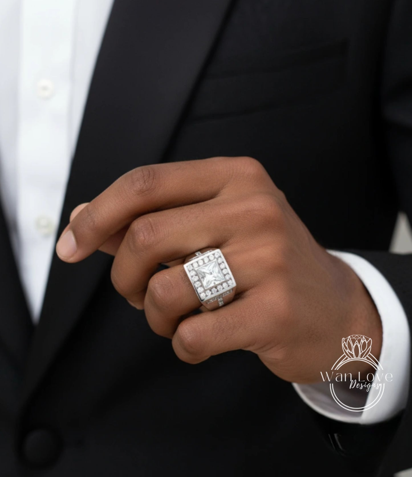 A close-up of a person's hand wearing a large diamond ring on the ring finger.