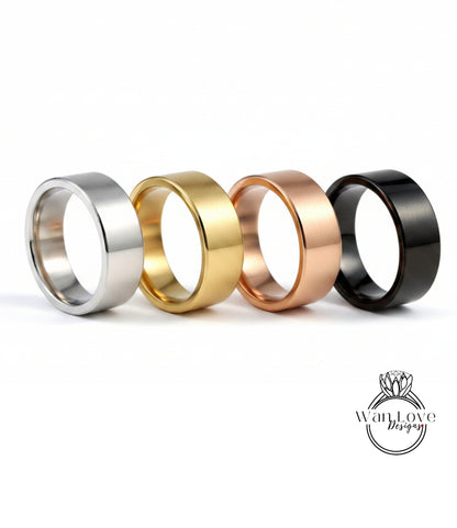 four different styles of rings, including silver, gold, copper, and black, arranged in a row.