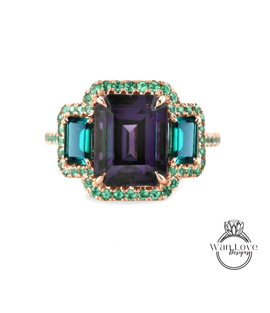 A ring with a large purple gemstone surrounded by smaller green gemstones, set in a gold band with a green accent.
