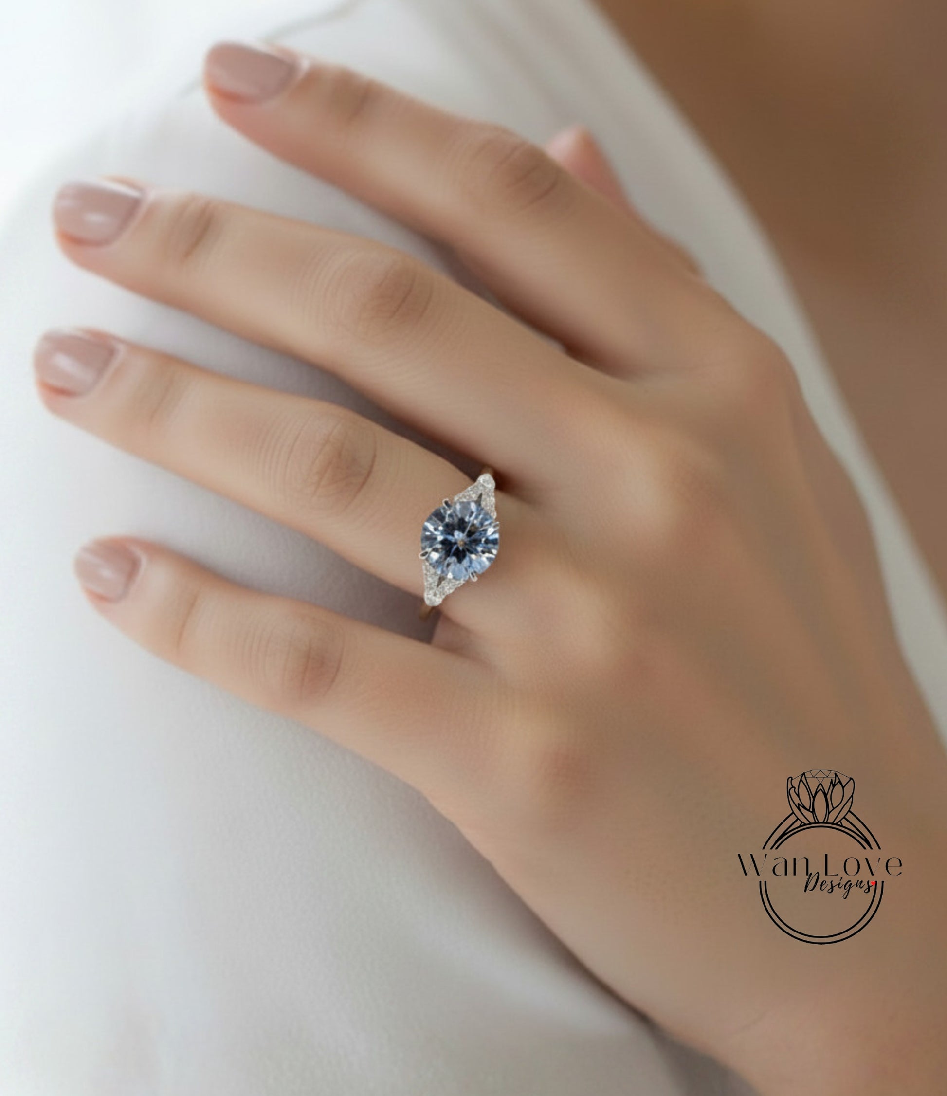 A close-up of a person's hand wearing a diamond engagement ring.