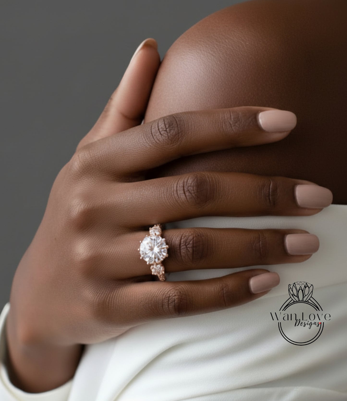 A close-up of a person's hand wearing a large, ornate engagement ring with a large central diamond surrounded by smaller diamonds.