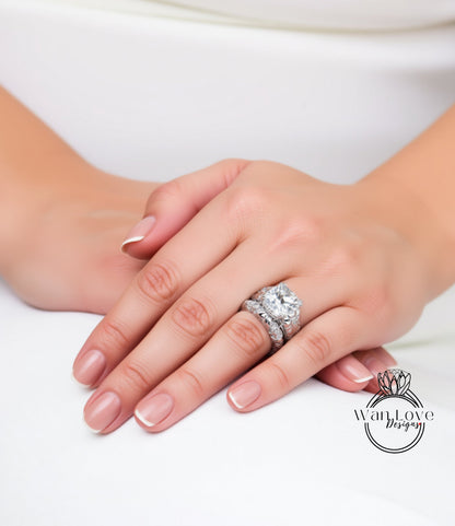 A close-up of a person's hands wearing a large diamond engagement ring.