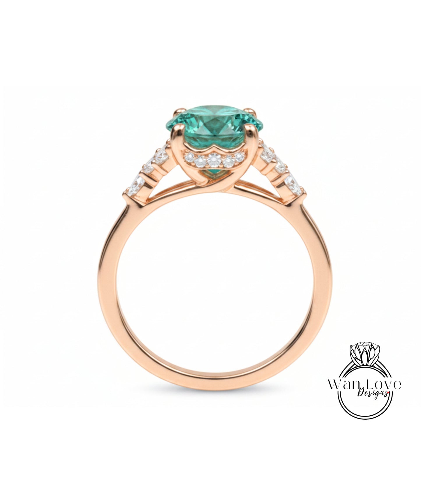 A gold ring with a large, green gemstone set in the center, surrounded by smaller diamonds.