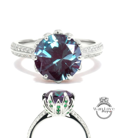 A stunning ring featuring a large, deep blue gemstone surrounded by a silver band and accented with green gemstones.