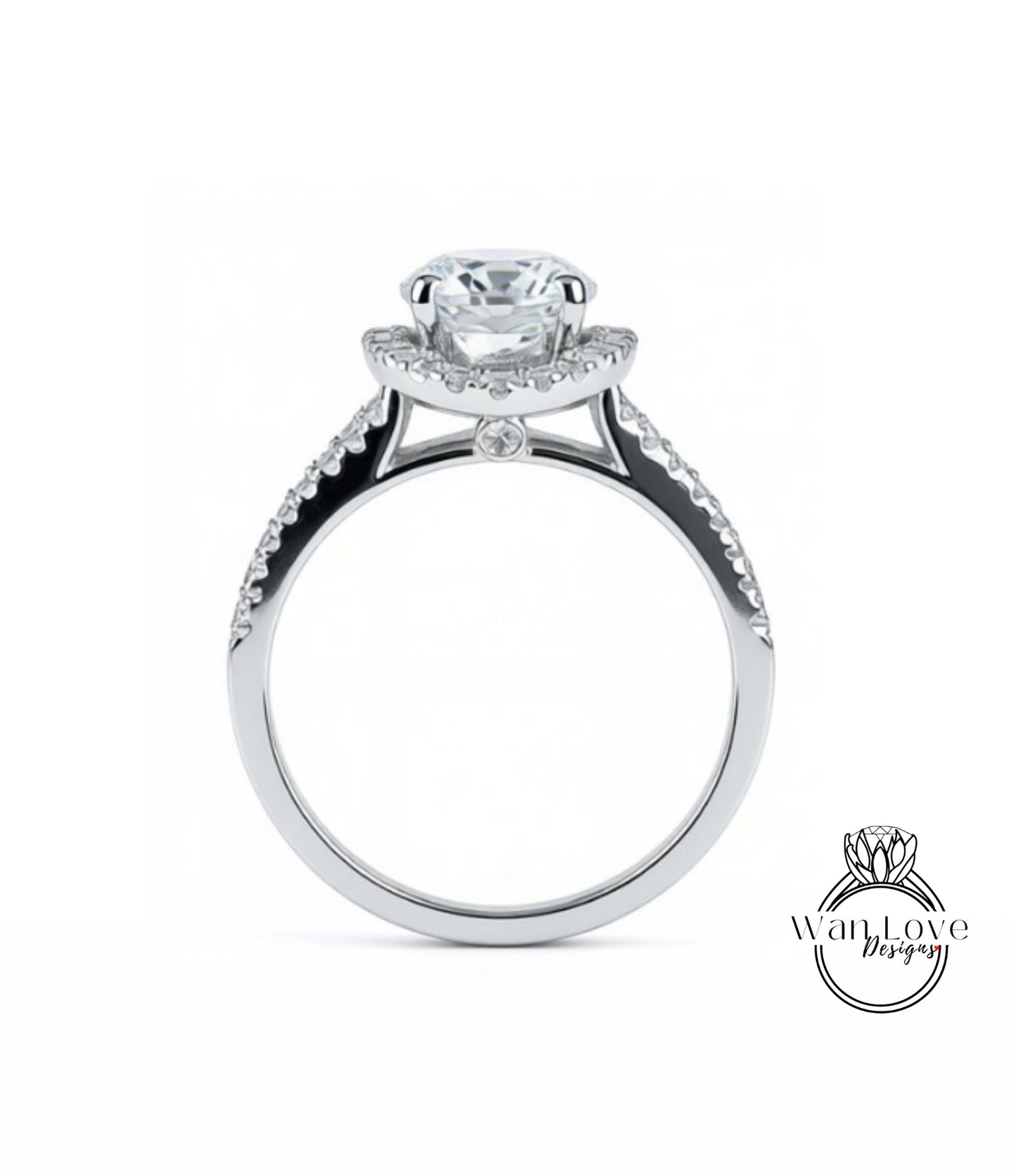 A silver engagement ring with a large central diamond and smaller diamonds on either side of the halo.