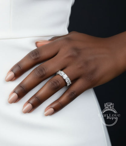 A close-up of a hand wearing a diamond ring on the ring finger.