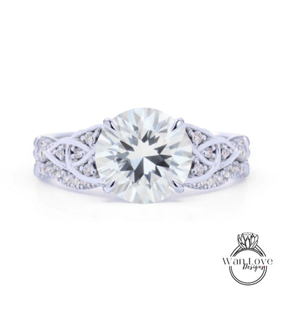 A close-up of a diamond engagement ring with a large, brilliant-cut diamond set in a silver band adorned with smaller diamonds.