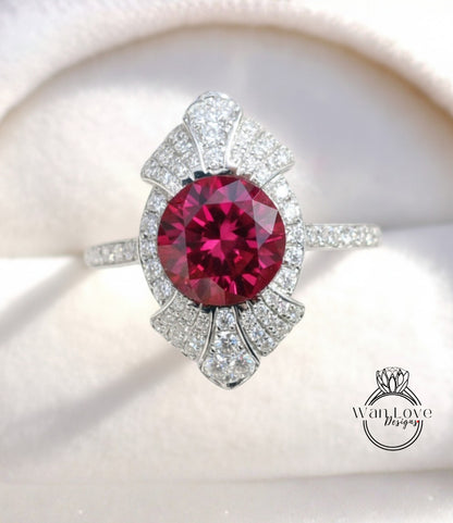 A close-up image of a stunning ring featuring a large, deep red gemstone surrounded by a sparkling diamond-encrusted band.