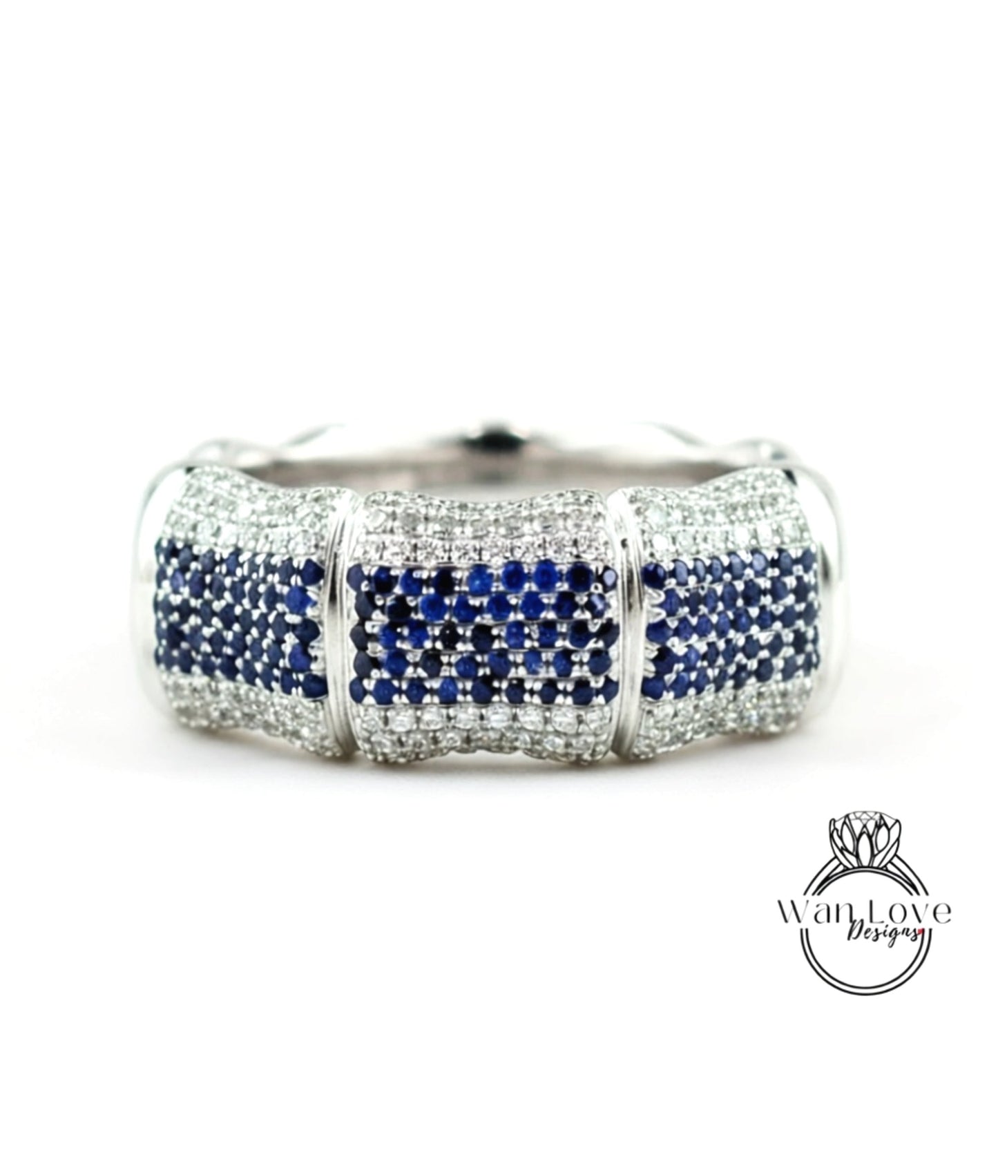 A silver and blue diamond bracelet with a large central diamond surrounded by smaller diamonds on either side.