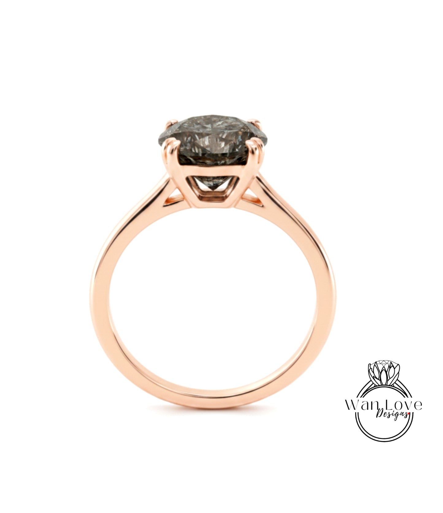 A rose gold engagement ring with a large, dark grey diamond set in the center.