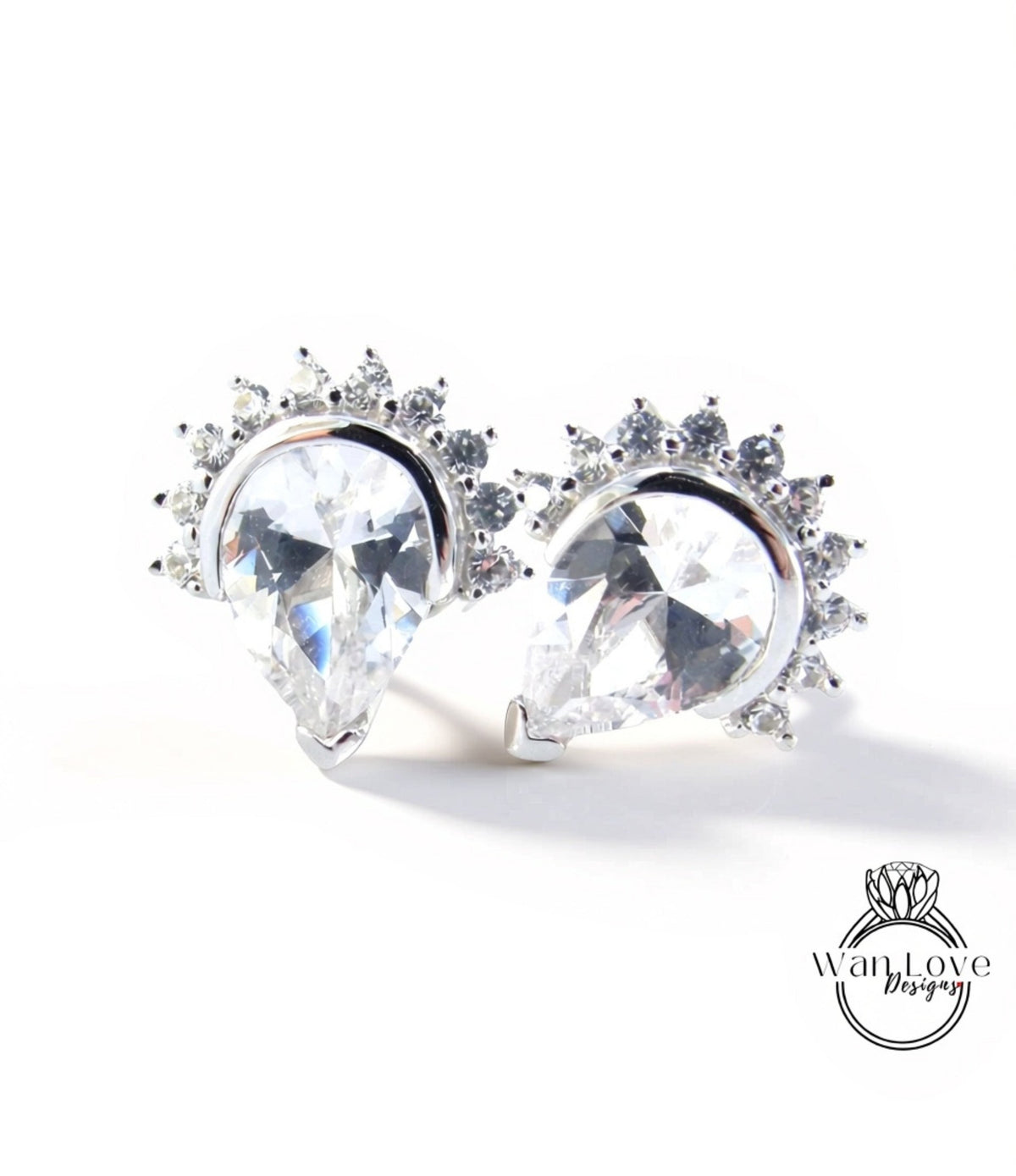 two elegant earrings with large, clear gemstones set in a decorative metal frame.