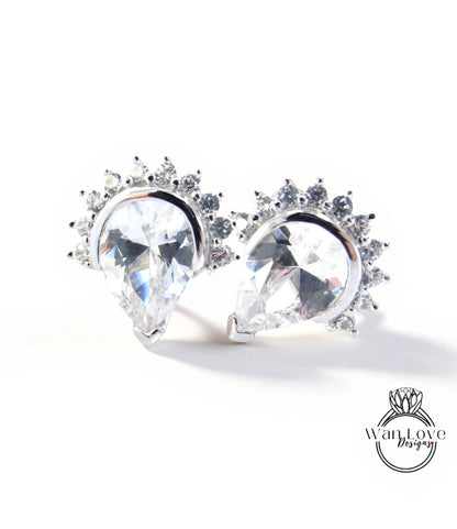 two elegant earrings with large, clear gemstones set in a decorative metal frame.